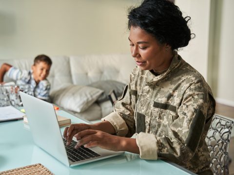 Black,Woman,Soldier,Using,Laptop,At,Home