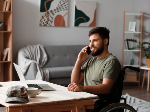 Soldier,In,Wheelchair,Talking,By,Mobile,Phone,At,Home